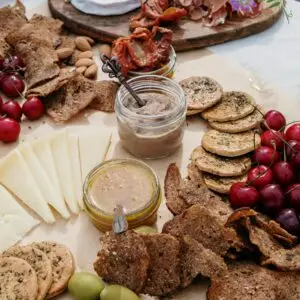 A delectable spread featuring cheese, cured meats, olives, and fresh cherries perfect for a picnic or brunch.